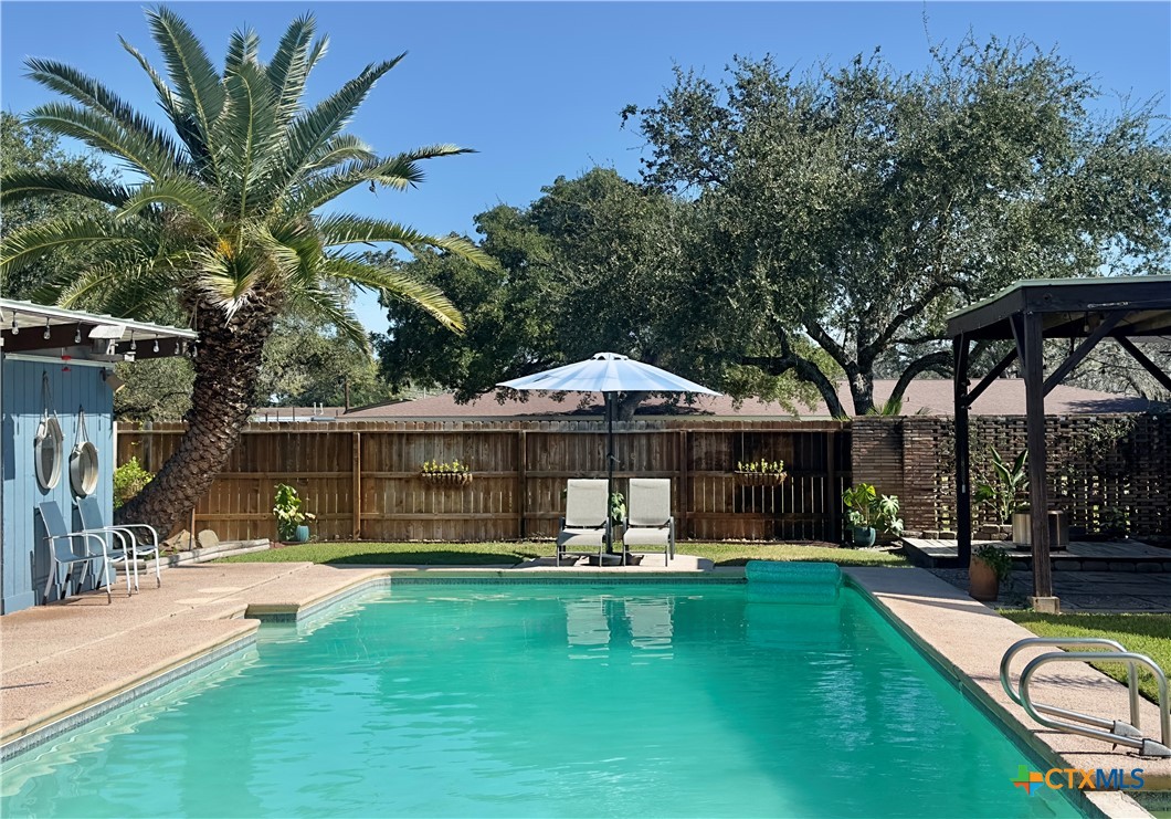 601 Lawrence Street Refugio, TX 78377 - Photo 30 of 42 a swimming pool view with a seating space and a garden