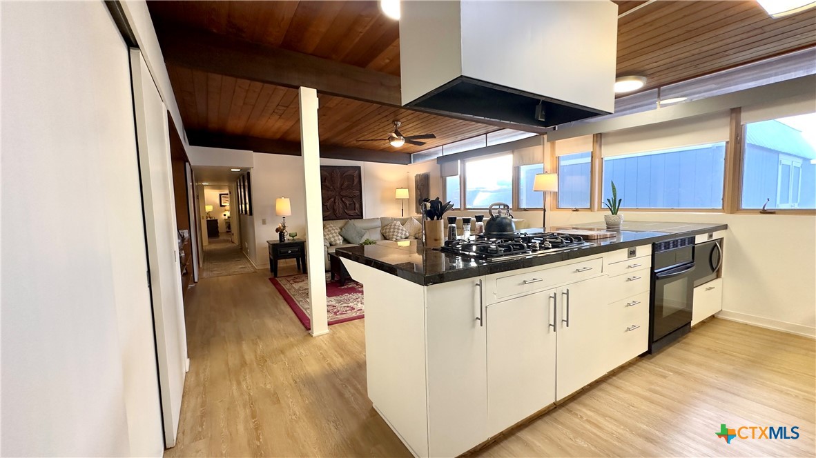 601 Lawrence Street Refugio, TX 78377 - Photo 7 of 42 a kitchen with stainless steel appliances kitchen island granite countertop a sink and cabinets