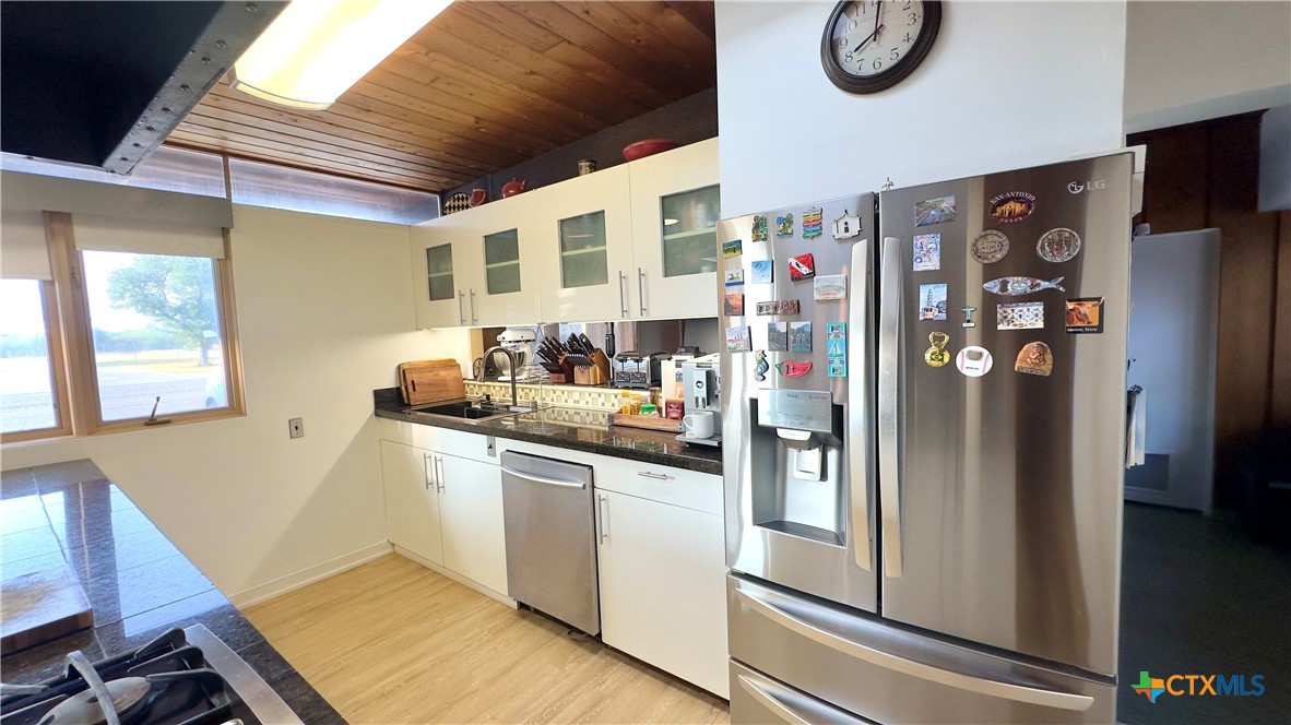 601 Lawrence Street Refugio, TX 78377 - Photo 8 of 42 a kitchen with stainless steel appliances granite countertop a refrigerator and a sink
