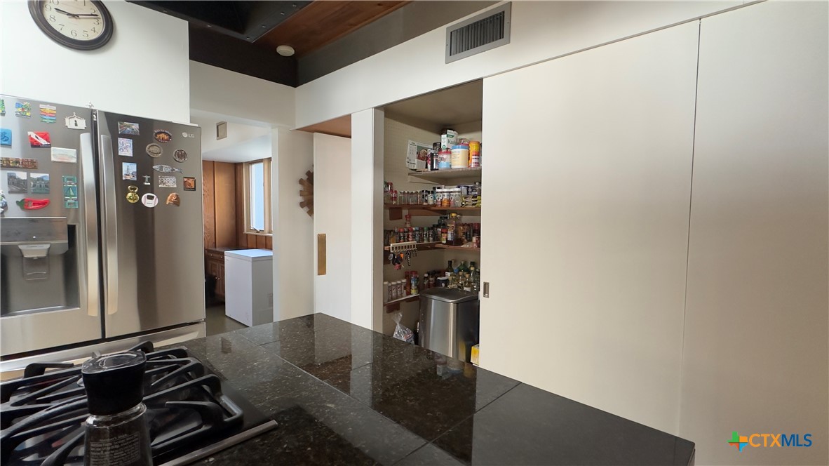 601 Lawrence Street Refugio, TX 78377 - Photo 9 of 42 a kitchen with a refrigerator and a stove