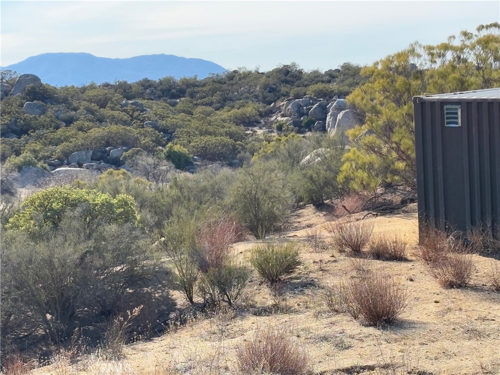 777 Ridgecrest Trail Aguanga, CA 92536 - Photo 11 of 28 a view of a wooden house with a yard