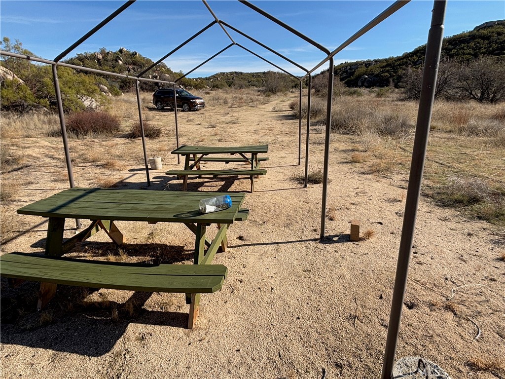 777 Ridgecrest Trail Aguanga, CA 92536 - Photo 2 of 28 a view of a backyard with a small table and chairs