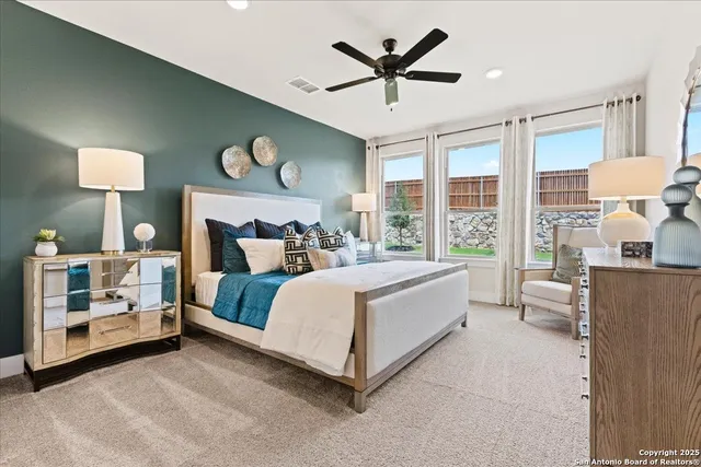 a en suite bathroom with a double vanity sink a mirror and a bathtub