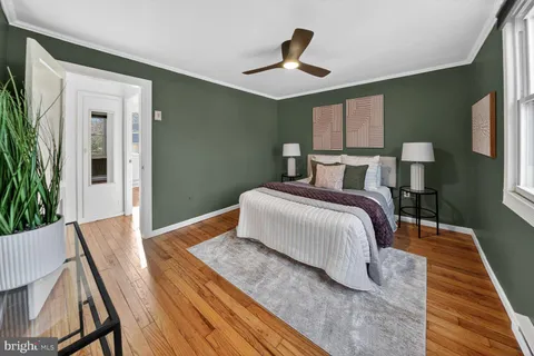 a bedroom with a bed and a potted plant
