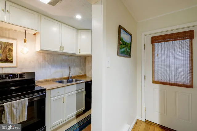 a kitchen with stainless steel appliances a stove a sink and a refrigerator
