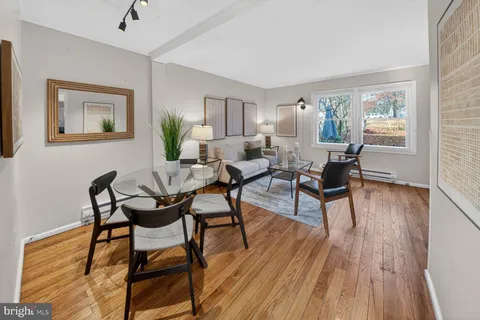 a dining room with furniture and wooden floor