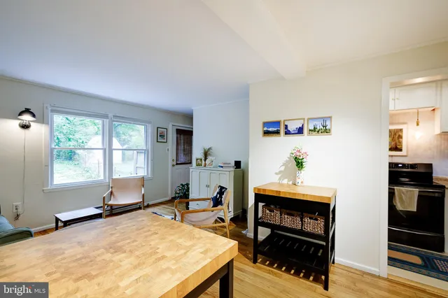 a living room with furniture a window and a flat screen tv