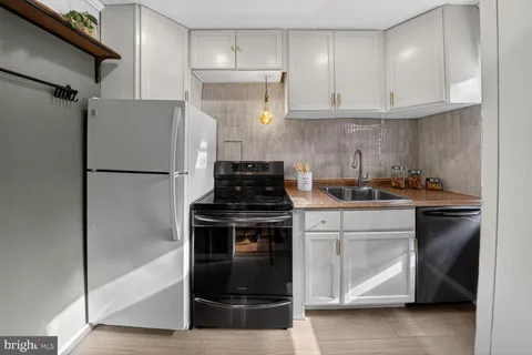 a kitchen with a refrigerator and a stove