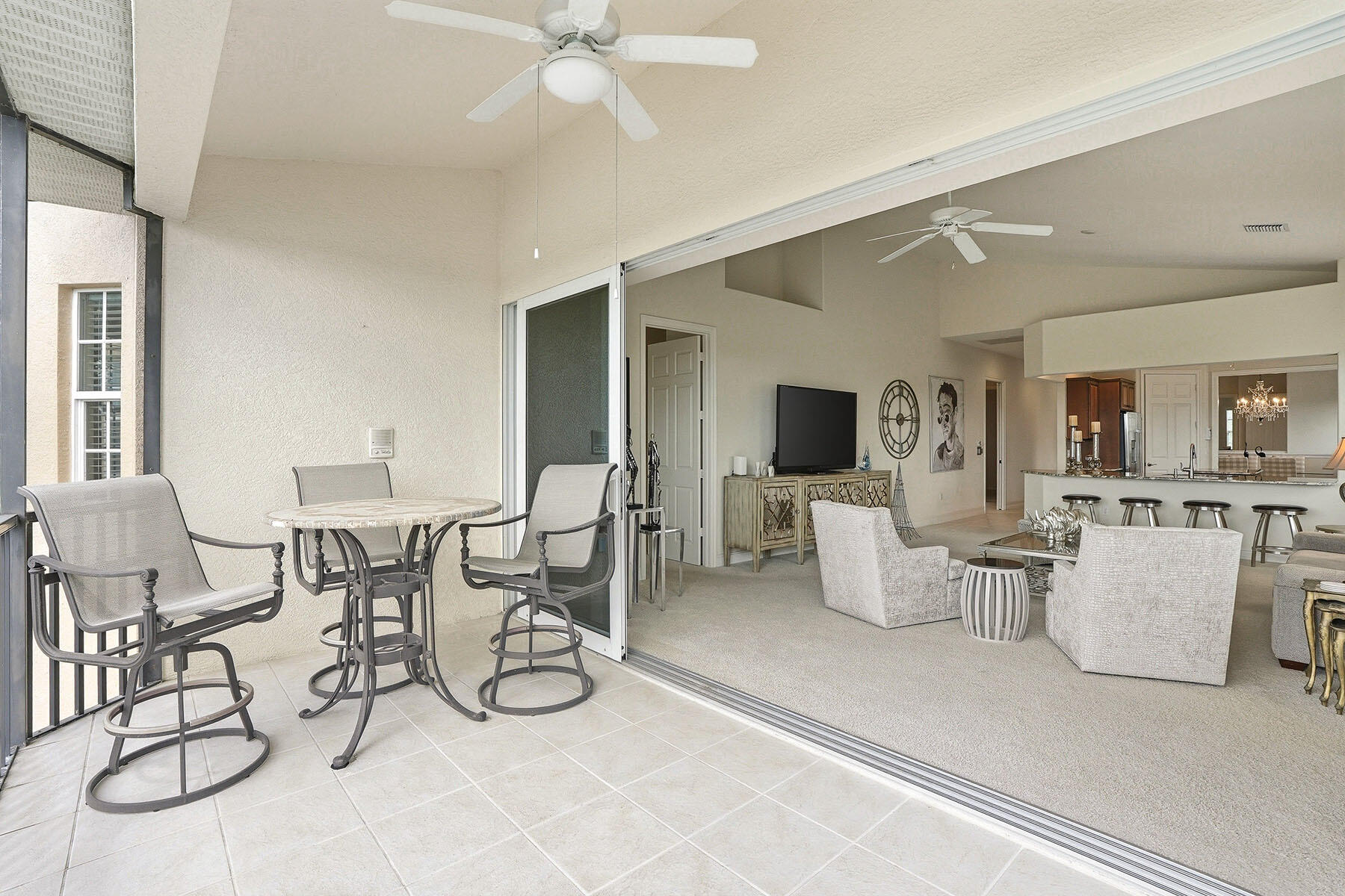 8605 Champions Point, Unit 103 Naples, FL 34113 - Photo 20 of 44 a view of a livingroom with furniture and a flat screen tv