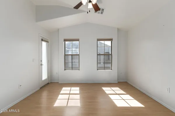 wooden floor in an empty room with a window