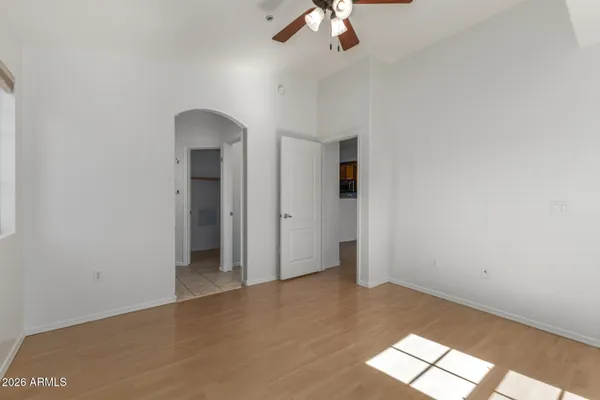 an empty room with chandelier fan