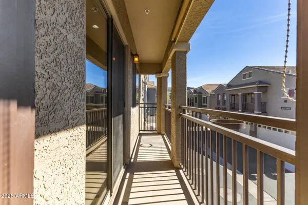 a view of a balcony with wooden floor and fence