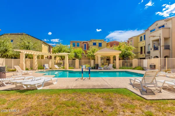 a view of a house with swimming pool and a yard