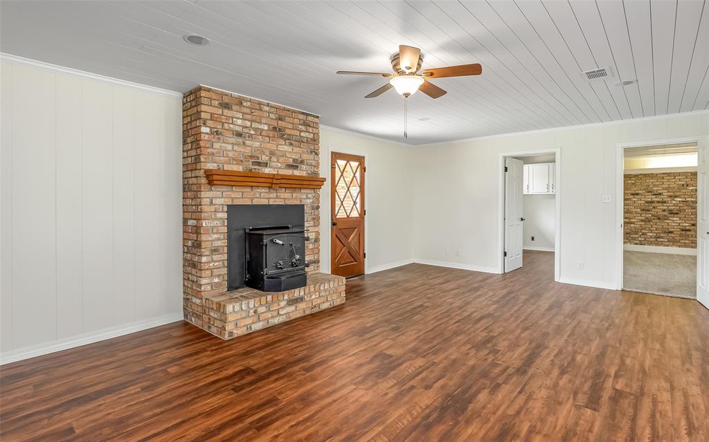 149 Southeast 6th Avenue Sibley, LA 71073 - Photo 11 of 38 a view of an empty room with wooden floor fireplace and a window