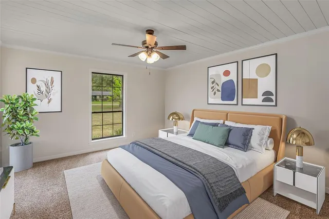 a bedroom with a large bed and a window