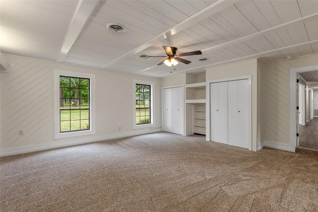 149 Southeast 6th Avenue Sibley, LA 71073 - Photo 20 of 38 an empty room with chandelier fan and windows