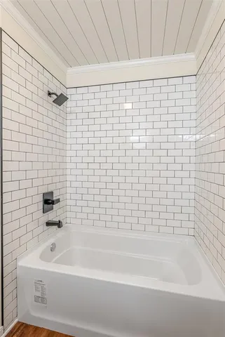 a bathroom with a bathtub and a shower
