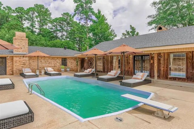 a patio with a table and chairs under an umbrella