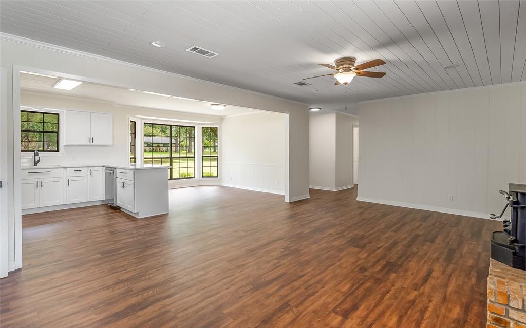 149 Southeast 6th Avenue Sibley, LA 71073 - Photo 9 of 38 a view of an empty room with a window and wooden floor