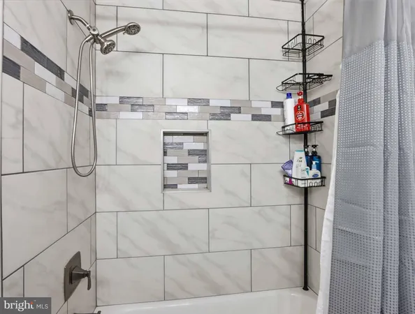 a bathroom with a refrigerator and a sink