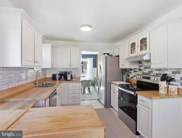 a kitchen with cabinets and stainless steel appliances