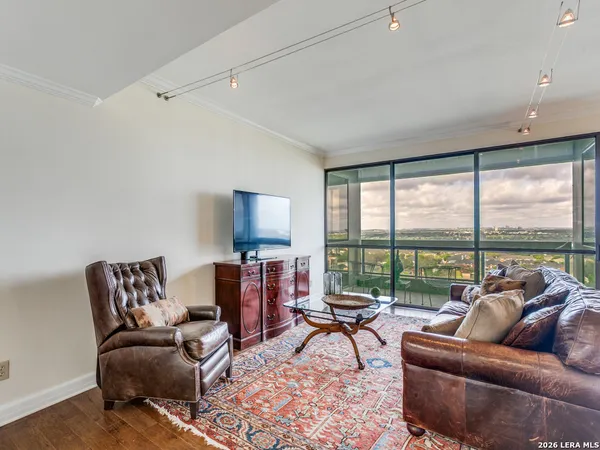 a living room with furniture and a large window