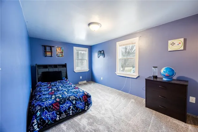 a bedroom with a large bed and a window