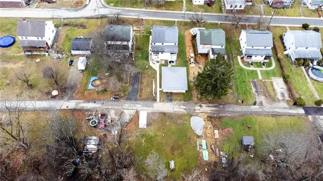 a aerial view of a house with a yard patio and fire pit