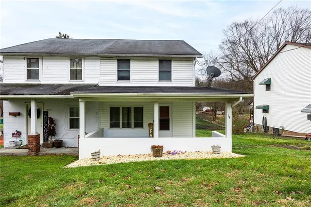 a front view of a house with a yard