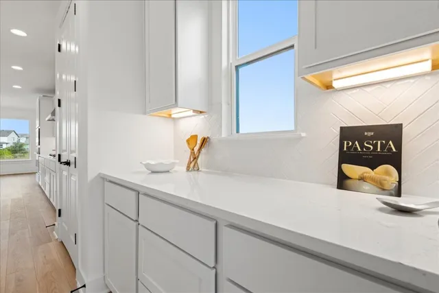 a hallway with a sink and a window