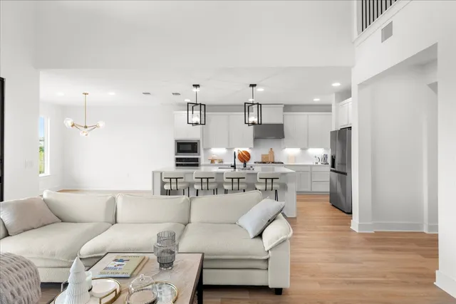 a living room with furniture and a wooden floor