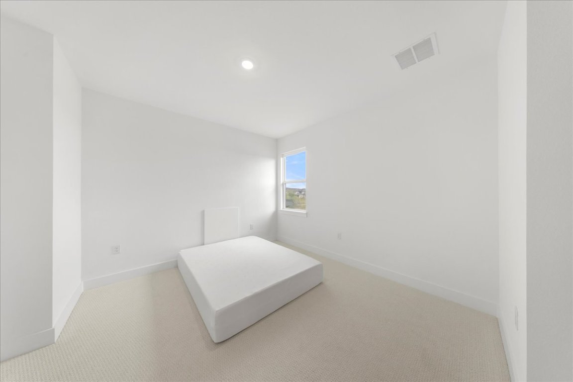 8700 Olmsted Way Austin, TX 78744 - Photo 26 of 40 Unfurnished bedroom featuring carpet floors and recessed lighting