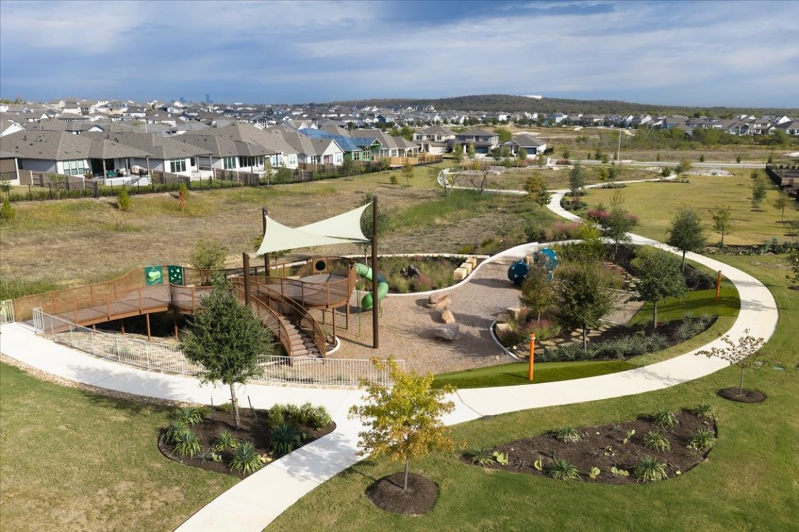 8700 Olmsted Way Austin, TX 78744 - Photo 35 of 40 Surrounding community with a residential view and a yard