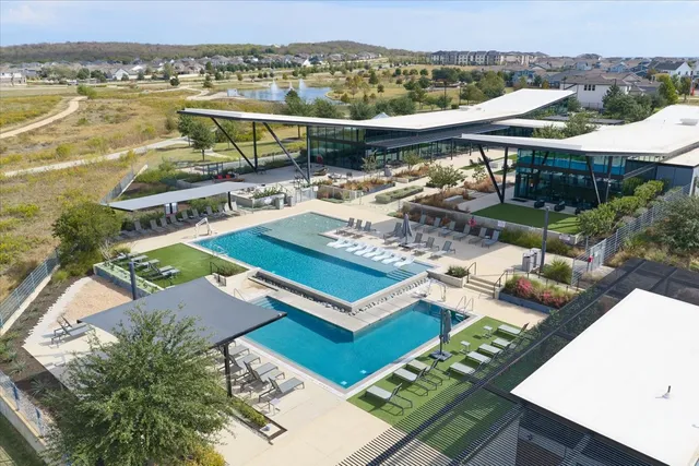an aerial view of a house with swimming pool garden and patio
