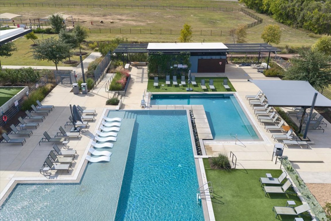 8700 Olmsted Way Austin, TX 78744 - Photo 39 of 40 Community pool with a patio, a view of rural / pastoral area, and a pergola