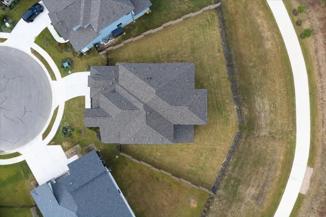 an aerial view of a house with a yard
