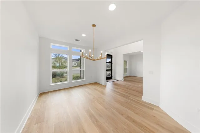 a view of a room with wooden floor fan and window