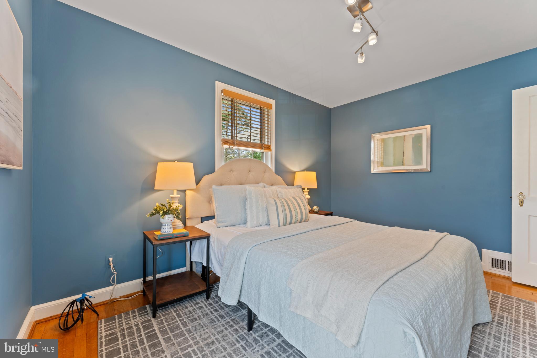 9906 Rogart Road Silver Spring, MD 20901 - Photo 23 of 68 a bedroom with a bed and window