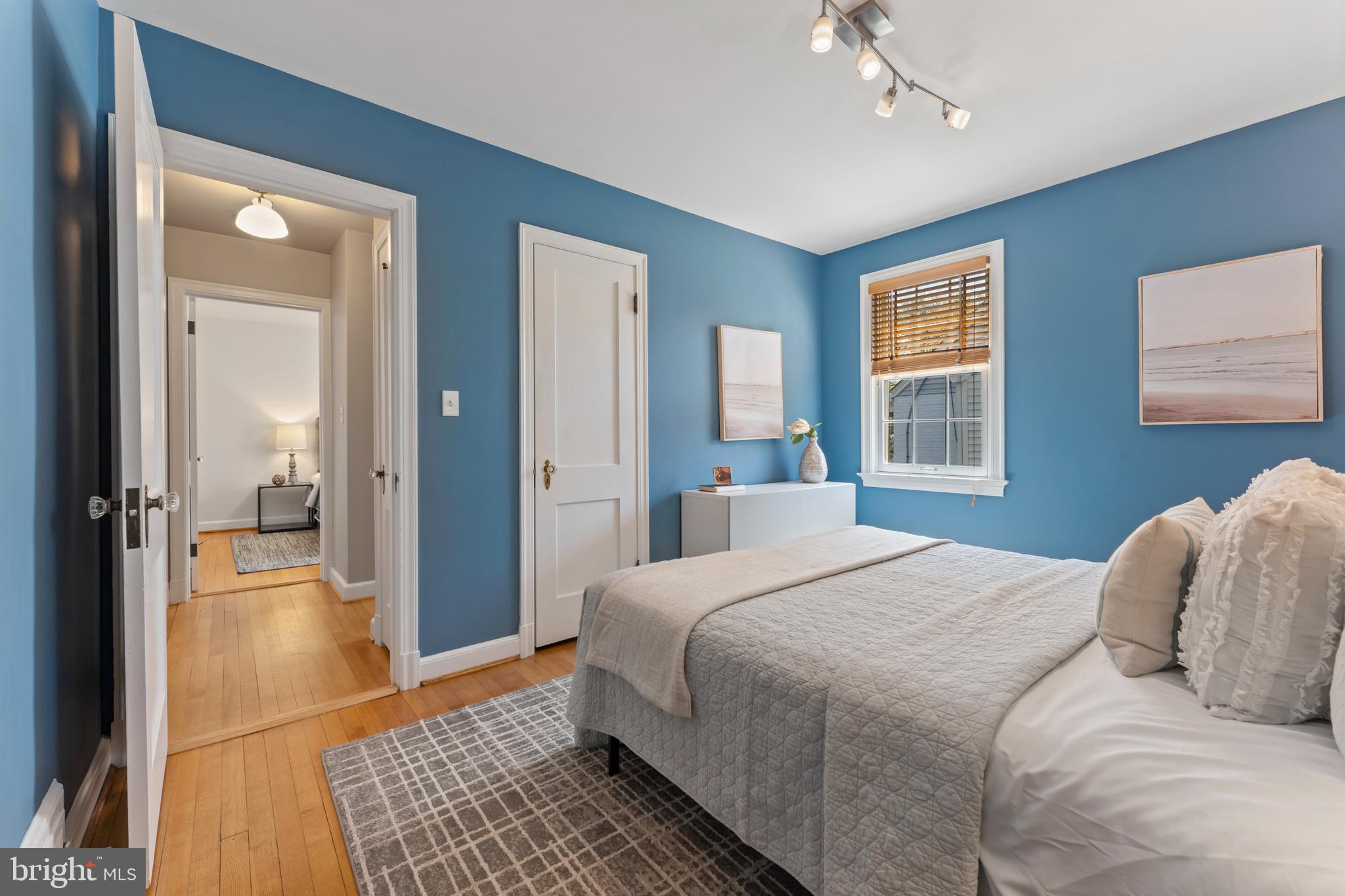 9906 Rogart Road Silver Spring, MD 20901 - Photo 25 of 68 a bedroom with a bed and a chandelier