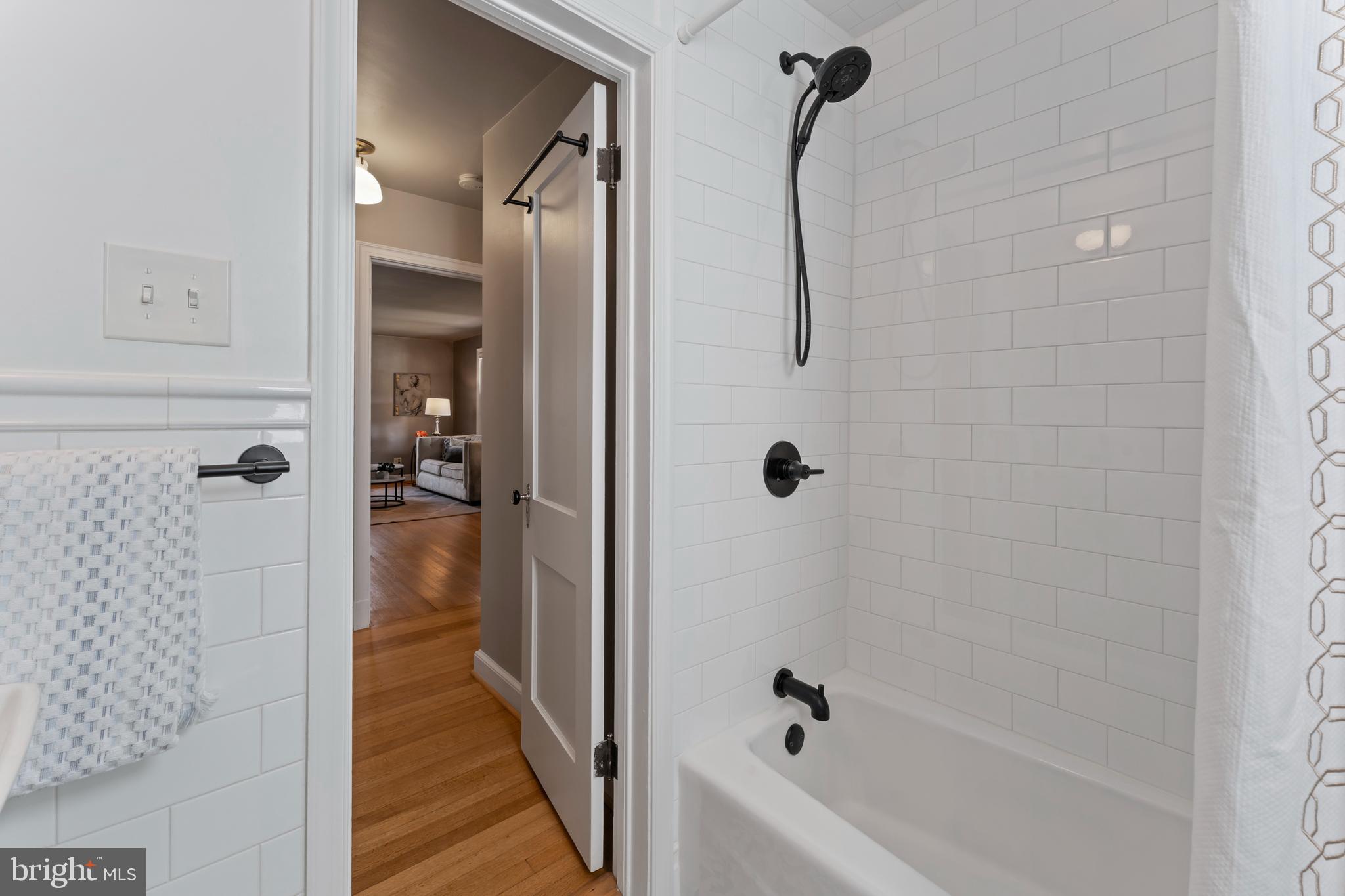 9906 Rogart Road Silver Spring, MD 20901 - Photo 31 of 68 a bathroom with a shower and a tub