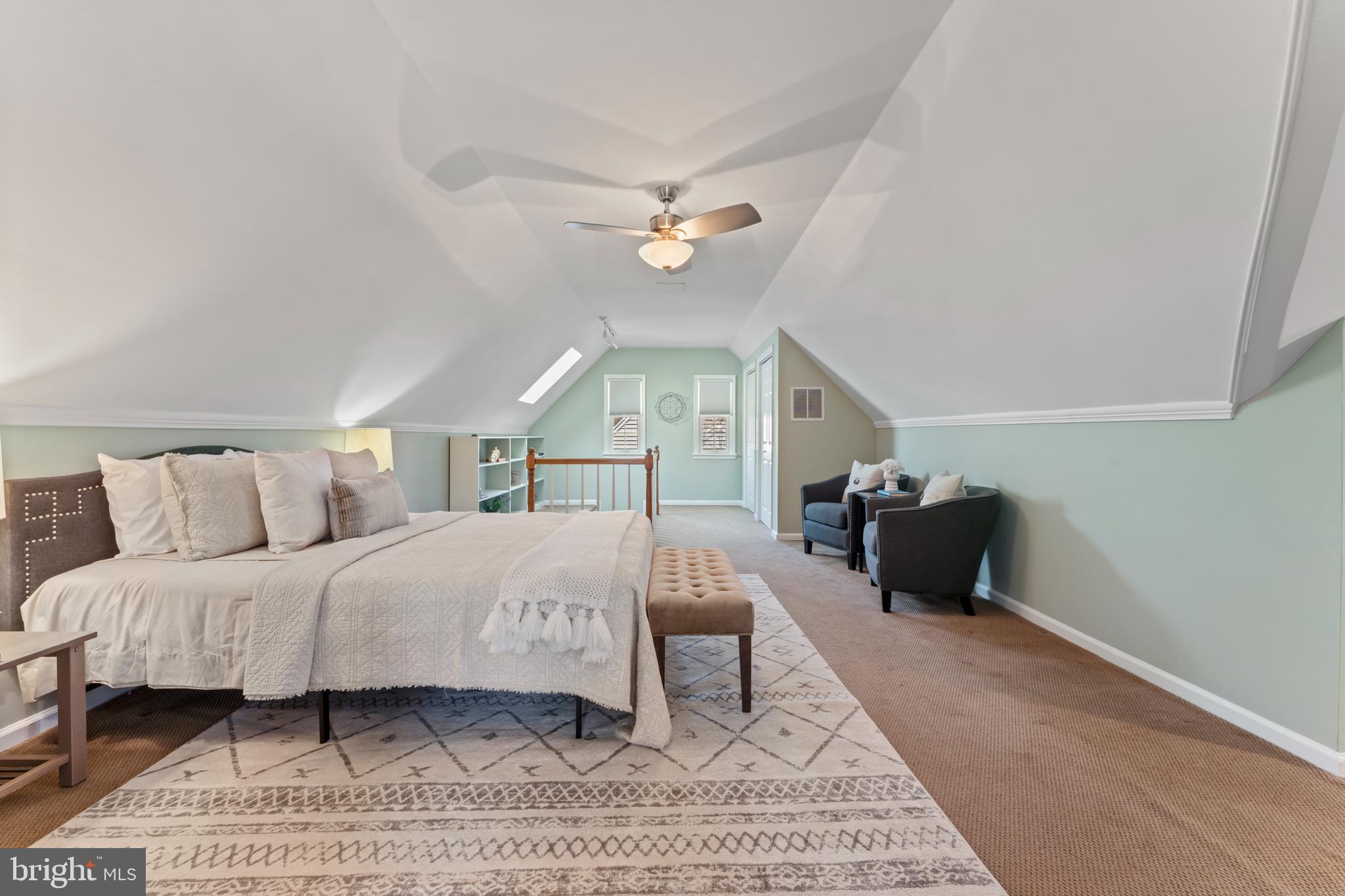 9906 Rogart Road Silver Spring, MD 20901 - Photo 37 of 68 a bedroom with a bed rug and a wall painting