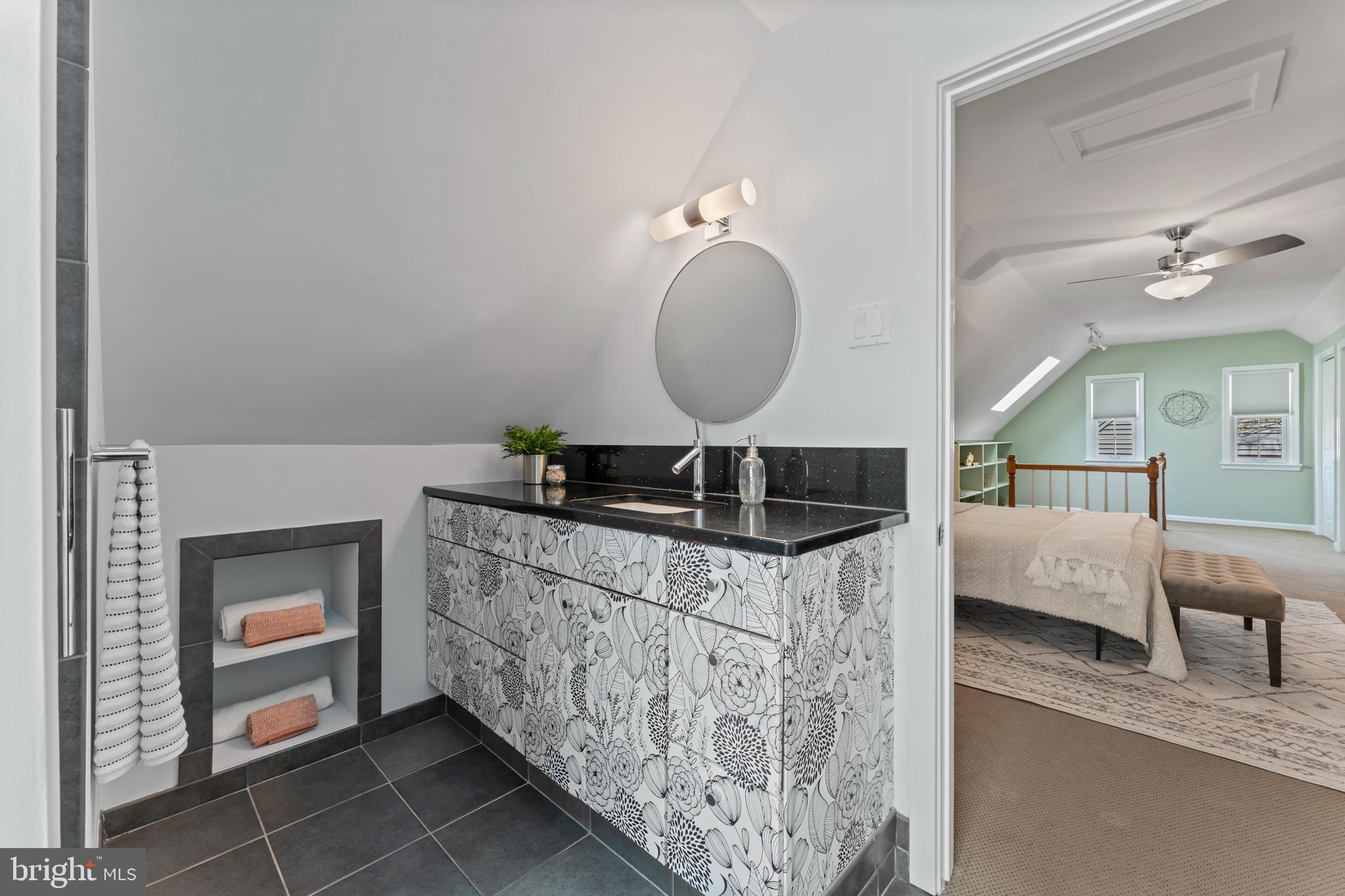 9906 Rogart Road Silver Spring, MD 20901 - Photo 42 of 68 a en suite bathroom with a granite countertop sink and a mirror