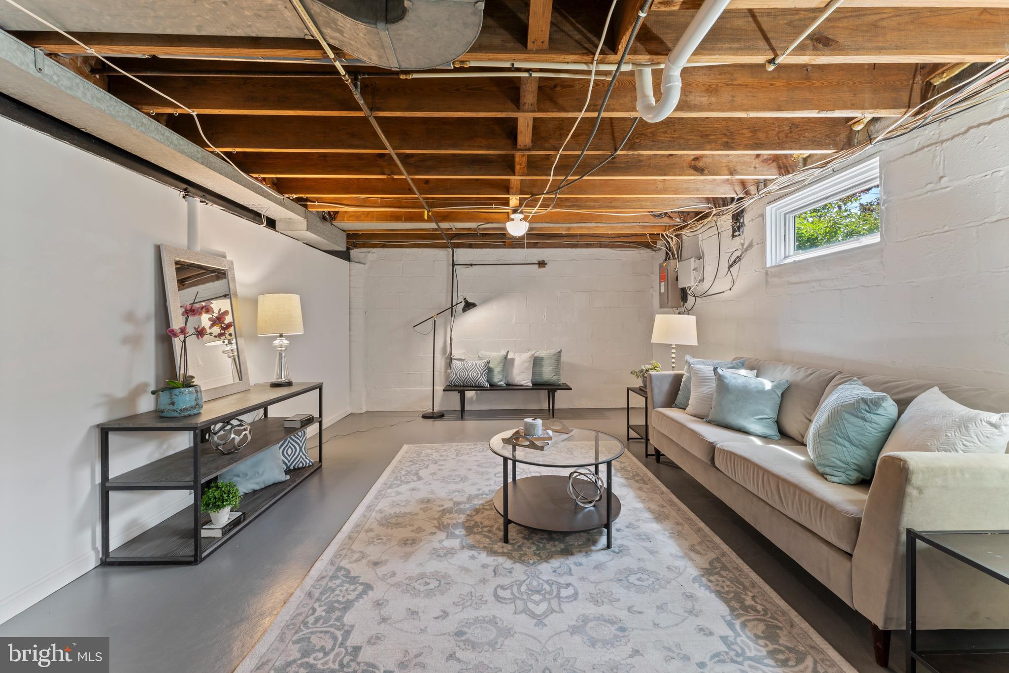 9906 Rogart Road Silver Spring, MD 20901 - Photo 51 of 68 a living room with furniture and a chandelier