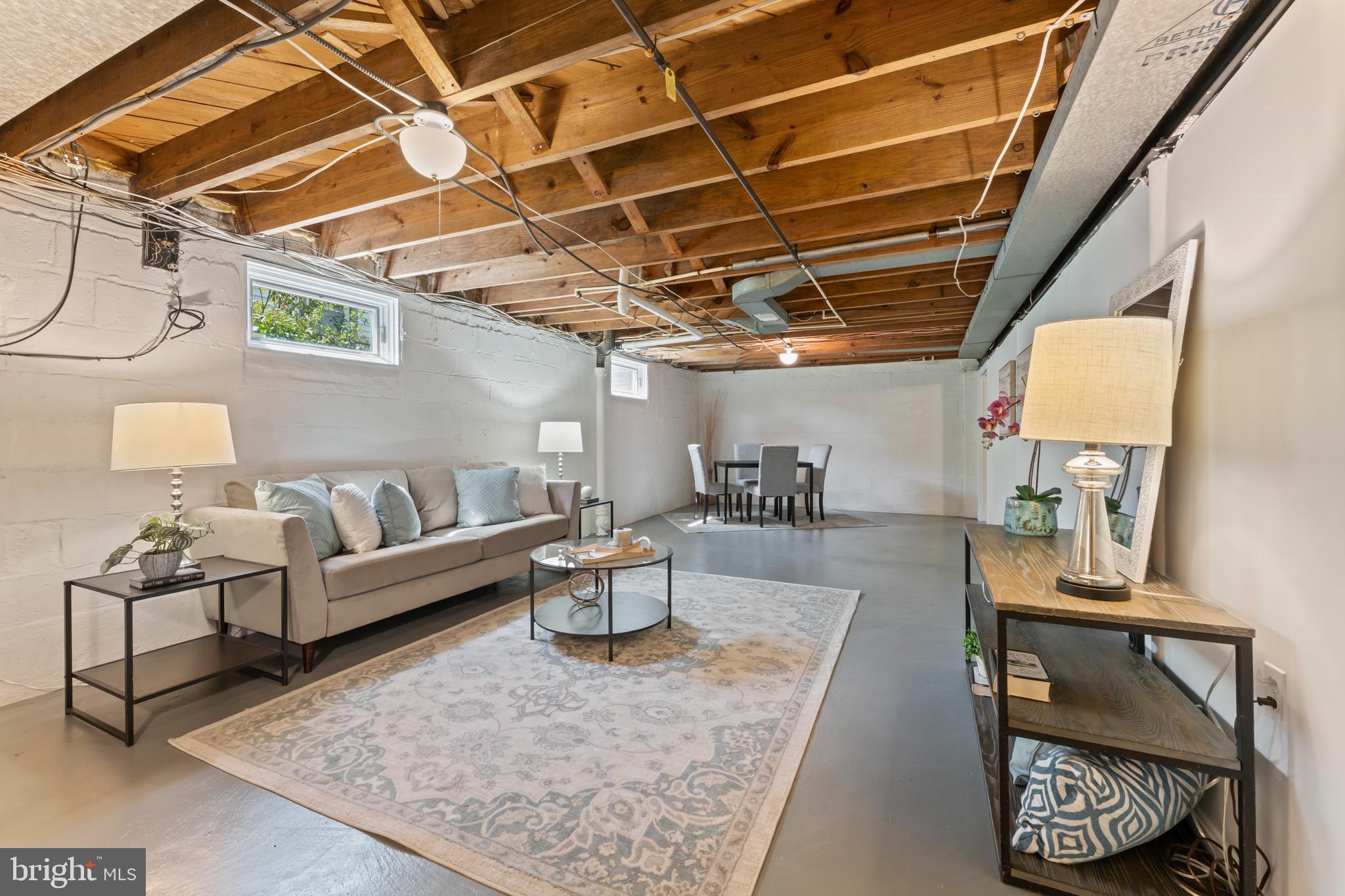 9906 Rogart Road Silver Spring, MD 20901 - Photo 52 of 68 a living room with furniture and a chandelier