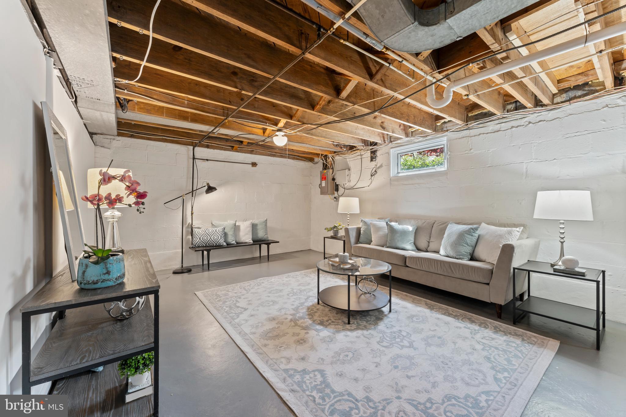 9906 Rogart Road Silver Spring, MD 20901 - Photo 53 of 68 a living room with furniture and a chandelier