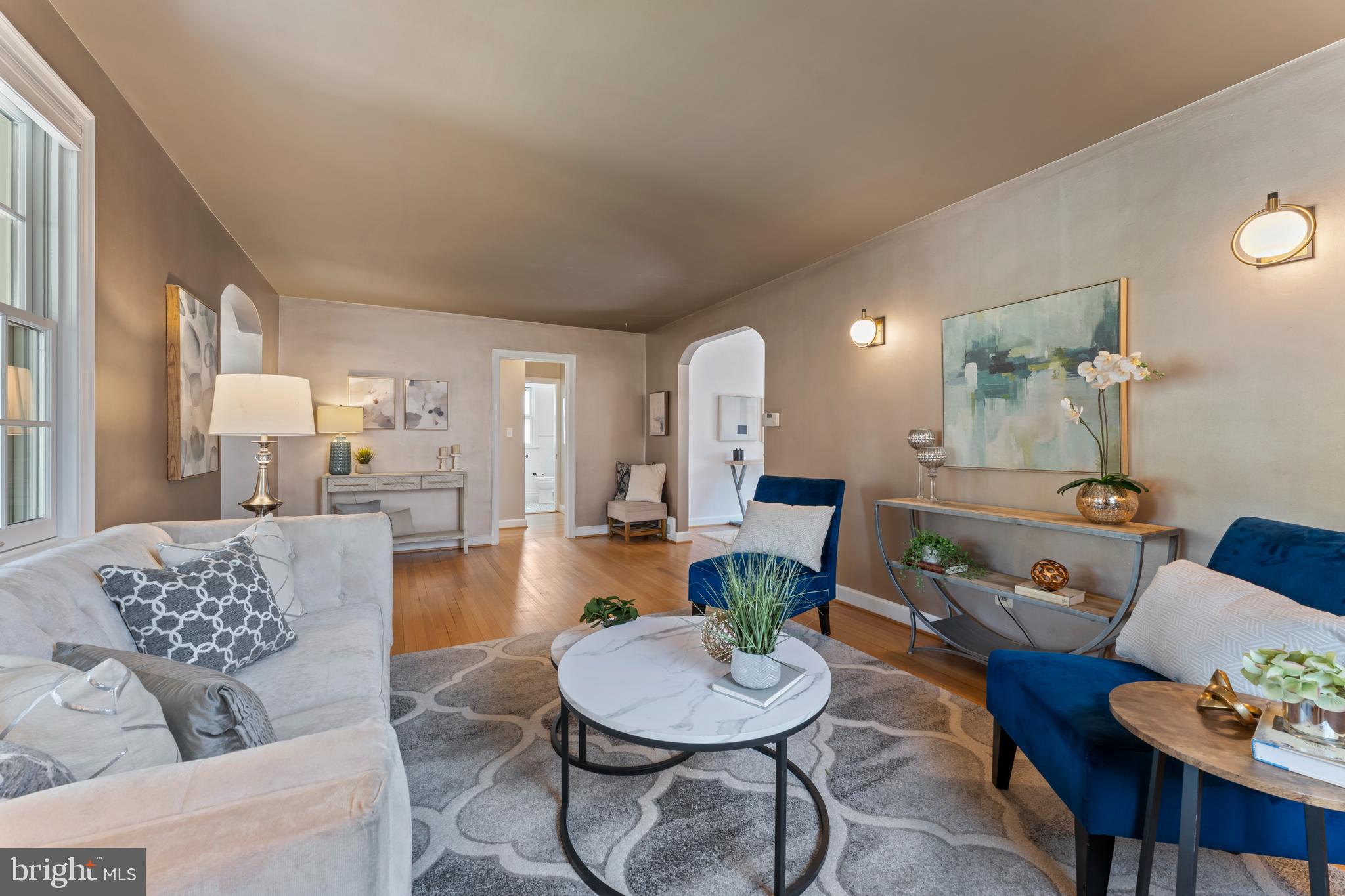 9906 Rogart Road Silver Spring, MD 20901 - Photo 9 of 68 a living room with furniture and a dining table with wooden floor