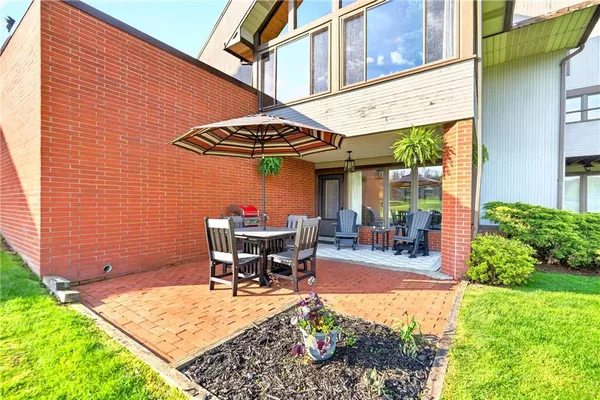 a view of a patio with table and chairs under an umbrella