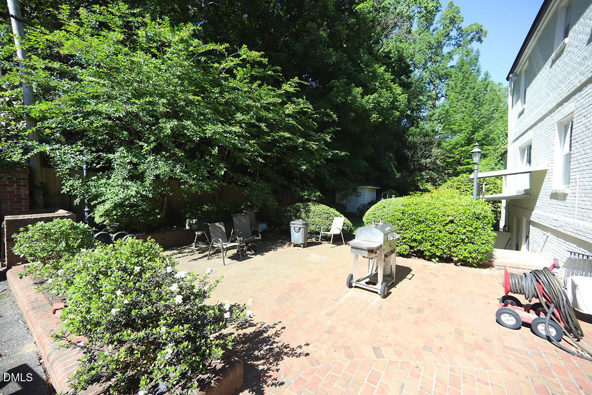 2601 York Road Raleigh, NC 27608 - Photo 20 of 24 a view of a backyard with potted plants and large trees