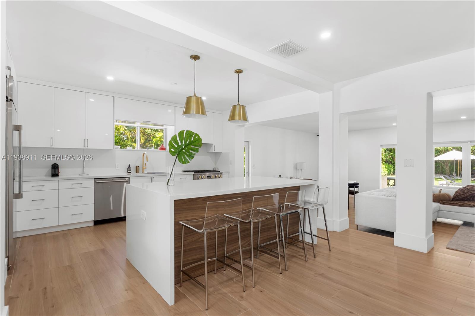 7825 Southwest 72nd Avenue Miami, FL 33143 - Photo 13 of 30 a kitchen with stainless steel appliances kitchen island granite countertop a table chairs and a refrigerator