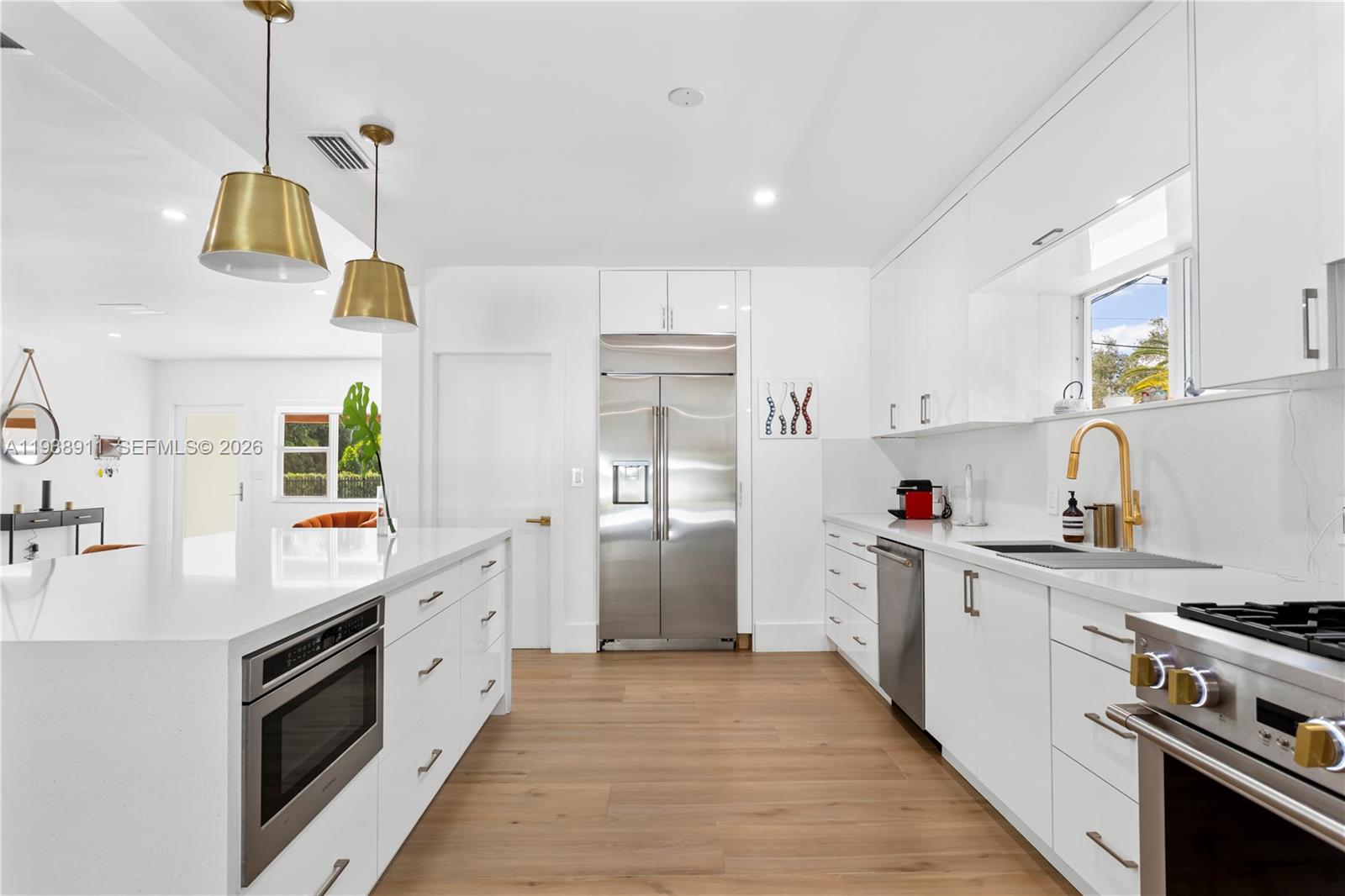 7825 Southwest 72nd Avenue Miami, FL 33143 - Photo 15 of 30 a kitchen with stainless steel appliances granite countertop a stove a sink and a refrigerator